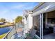 Private balcony with table and chairs, overlooking a canal at 2516 Woodgate Blvd # 206, Orlando, FL 32822