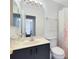 Bathroom with shower/tub combo, toilet and vanity with dark cabinets at 2516 Woodgate Blvd # 206, Orlando, FL 32822