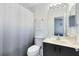 Clean bathroom with shower/tub combo, toilet, and vanity with dark cabinets at 2516 Woodgate Blvd # 206, Orlando, FL 32822