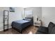 Small bedroom with a double bed, nightstand and small couch at 2516 Woodgate Blvd # 206, Orlando, FL 32822
