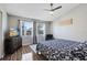 Spacious bedroom with a king-size bed, large windows, and a ceiling fan at 2516 Woodgate Blvd # 206, Orlando, FL 32822