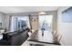 Bright dining area with table and chairs, near sliding doors to patio and water views at 2516 Woodgate Blvd # 206, Orlando, FL 32822