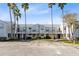 Exterior view of the building, showcasing the parking lot and landscaping at 2516 Woodgate Blvd # 206, Orlando, FL 32822