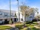 Side view of the building showcasing landscaping and walkway at 2516 Woodgate Blvd # 206, Orlando, FL 32822