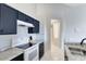 White appliances and dark cabinets in this galley-style kitchen at 2516 Woodgate Blvd # 206, Orlando, FL 32822