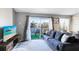 Living room with balcony access and lake view at 2516 Woodgate Blvd # 206, Orlando, FL 32822