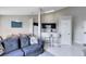 Open living room features a comfy couch, dining area, and kitchen with breakfast bar at 2516 Woodgate Blvd # 206, Orlando, FL 32822