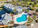Community pool with surrounding lounge chairs and patio area at 2516 Woodgate Blvd # 206, Orlando, FL 32822
