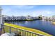 Balcony view overlooking a lake with fountain and community buildings at 2516 Woodgate Blvd # 206, Orlando, FL 32822