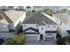 Two-story house with gray siding, three-car garage, and landscaping at 289 Auburn Ave, Kissimmee, FL 34747