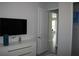 Bright bedroom with a TV and access to another room at 289 Auburn Ave, Kissimmee, FL 34747