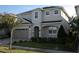 Two-story house with gray siding, a three-car garage, and landscaping at 289 Auburn Ave, Kissimmee, FL 34747