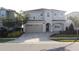Two-story house with gray siding, three-car garage, and landscaping at 289 Auburn Ave, Kissimmee, FL 34747