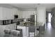 Modern kitchen with granite island, stainless steel appliances, and white cabinets at 289 Auburn Ave, Kissimmee, FL 34747