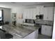 Spacious kitchen with granite countertops, stainless steel appliances, and white cabinets at 289 Auburn Ave, Kissimmee, FL 34747