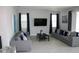 Spacious living room featuring comfortable sofas and a large TV at 289 Auburn Ave, Kissimmee, FL 34747