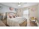 Bedroom with white bedding, ceiling fan, and decorative accents at 304 Jacksonville Ct, Kissimmee, FL 34759