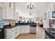 Kitchen with white cabinets, stainless steel appliances, and breakfast bar at 304 Jacksonville Ct, Kissimmee, FL 34759