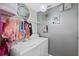 Bright laundry room with washer, dryer, and ample storage at 304 Jacksonville Ct, Kissimmee, FL 34759