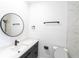 Bathroom with a round mirror, modern vanity, and marble tile at 326 Spinnaker Ct, Auburndale, FL 33823