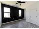 Bedroom with modern black geometric accent wall and ceiling fan at 326 Spinnaker Ct, Auburndale, FL 33823
