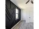 Bedroom featuring a black geometric accent wall and large window at 326 Spinnaker Ct, Auburndale, FL 33823