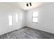 Bright bedroom with wood-look floors and multiple windows at 326 Spinnaker Ct, Auburndale, FL 33823