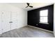 Bedroom with double doors and a geometric black accent wall at 326 Spinnaker Ct, Auburndale, FL 33823