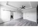 Main bedroom with barn door to en-suite bath and ceiling fan at 326 Spinnaker Ct, Auburndale, FL 33823