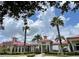 Community clubhouse with red roof and palm trees at 326 Spinnaker Ct, Auburndale, FL 33823