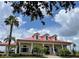Community clubhouse with red roof and white columns at 326 Spinnaker Ct, Auburndale, FL 33823