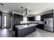 Modern kitchen with dark cabinetry, stainless steel appliances, and an island at 326 Spinnaker Ct, Auburndale, FL 33823
