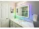 Modern bathroom with a large vanity, walk-in shower, and lighted mirror at 3383 Westchester Square Blvd # 202, Orlando, FL 32835