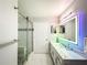 Modern bathroom with a large vanity, a walk-in shower, and a lighted mirror at 3383 Westchester Square Blvd # 202, Orlando, FL 32835