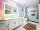 Modern bathroom with a large vanity, a walk-in shower, and a lighted mirror at 3383 Westchester Square Blvd # 202, Orlando, FL 32835