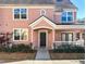 Two-story light pink house with dark brown front door and white railing at 3383 Westchester Square Blvd # 202, Orlando, FL 32835