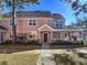 Pink two-story townhome with front porch and landscaping at 3383 Westchester Square Blvd # 202, Orlando, FL 32835