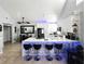 Modern kitchen with breakfast bar, stainless steel appliances, and white cabinetry at 3383 Westchester Square Blvd # 202, Orlando, FL 32835