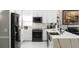 Modern white kitchen with quartz countertops and stainless steel appliances at 3383 Westchester Square Blvd # 202, Orlando, FL 32835