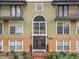 Condo building exterior featuring a well-maintained facade and attractive landscaping at 3936 Versailles Dr # 3936B, Orlando, FL 32808