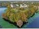Aerial view of community's waterfront location with lush trees at 3936 Versailles Dr # 3936B, Orlando, FL 32808