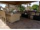 Outdoor kitchen with built-in grills and bar seating at 1063 S Hiawassee Rd # 1616, Orlando, FL 32835