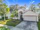 Two-story house with a two-car garage and a palm tree in the front yard at 12624 Maribou Cir, Orlando, FL 32828