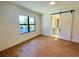 Spacious bedroom with light wood floors and an ensuite bathroom at 2161 Sharon Rd, Winter Park, FL 32789