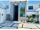 Contemporary home's entrance features a gray accent wall and a glass-paneled staircase at 2161 Sharon Rd, Winter Park, FL 32789