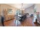 Formal dining room with hardwood floors, a large table, and a brick accent wall at 2351 Westwood Dr, Longwood, FL 32779