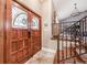 Elegant entry with double doors, stained glass, and a staircase with iron railing at 2351 Westwood Dr, Longwood, FL 32779