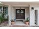 Inviting entryway with double doors, stained glass, and potted plants at 2351 Westwood Dr, Longwood, FL 32779