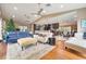 Open living space with hardwood floors, multiple seating areas, and kitchen access at 2351 Westwood Dr, Longwood, FL 32779