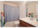 Clean bathroom with tub shower and wood vanity at 2430 Bittle Way, Saint Cloud, FL 34769